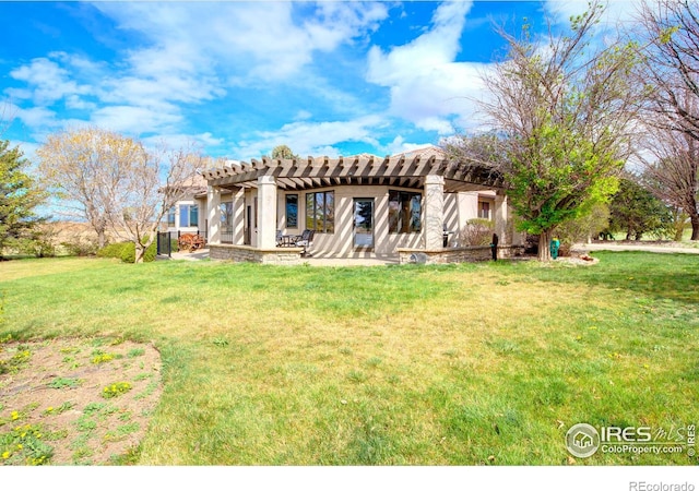 back of property with a yard and a pergola