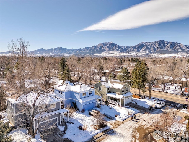 snowy aerial view featuring a mountain view