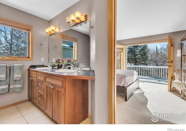 bathroom with double vanity, a sink, and a wealth of natural light