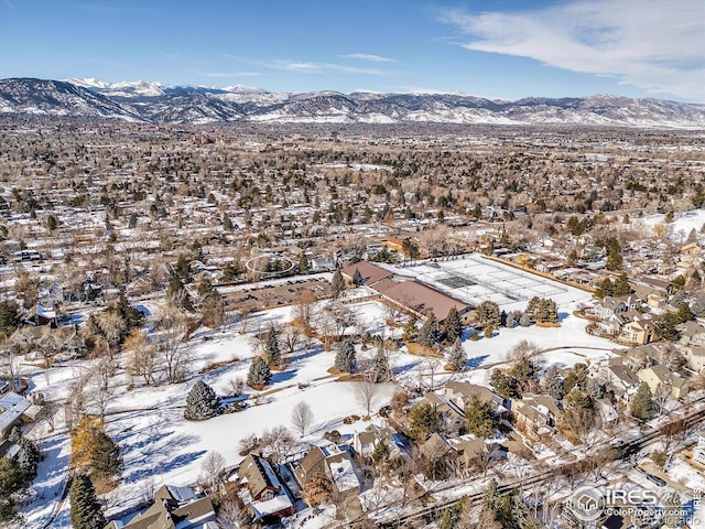 snowy aerial view with a residential view and a mountain view