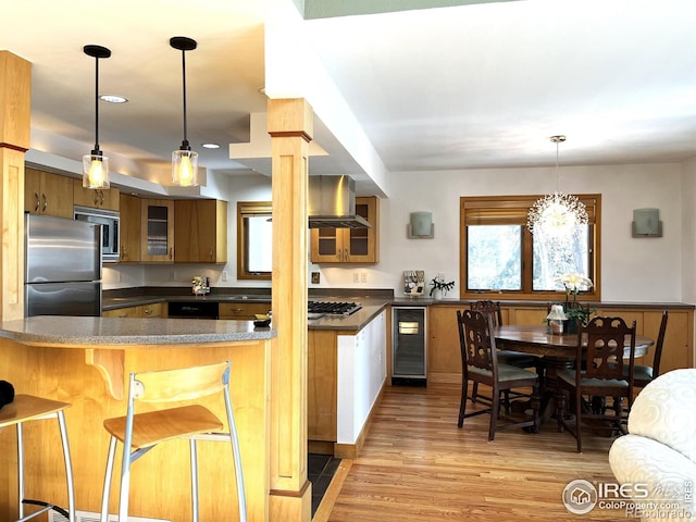 kitchen featuring dark countertops, wine cooler, glass insert cabinets, a peninsula, and stainless steel appliances