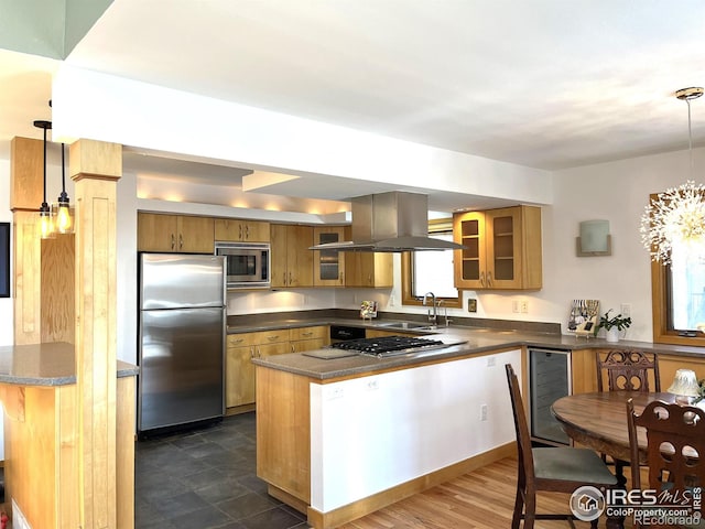 kitchen with appliances with stainless steel finishes, brown cabinetry, glass insert cabinets, and hanging light fixtures