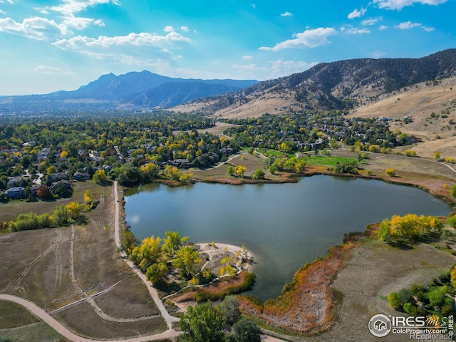 birds eye view of property featuring a water and mountain view