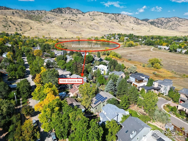 drone / aerial view with a water and mountain view