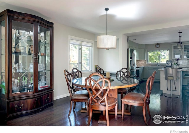 dining area with dark hardwood / wood-style floors and sink