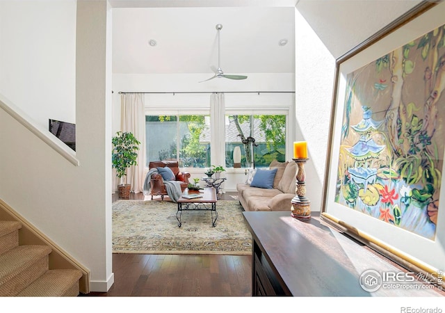 living room with dark wood-type flooring and ceiling fan