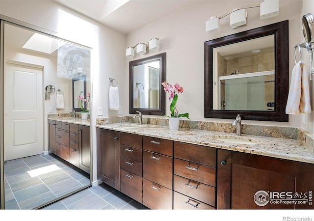 bathroom featuring vanity, an enclosed shower, and tile patterned flooring