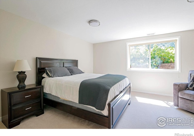 bedroom featuring light colored carpet