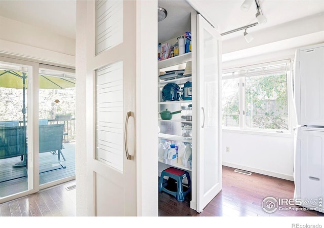 interior space with stacked washer and clothes dryer