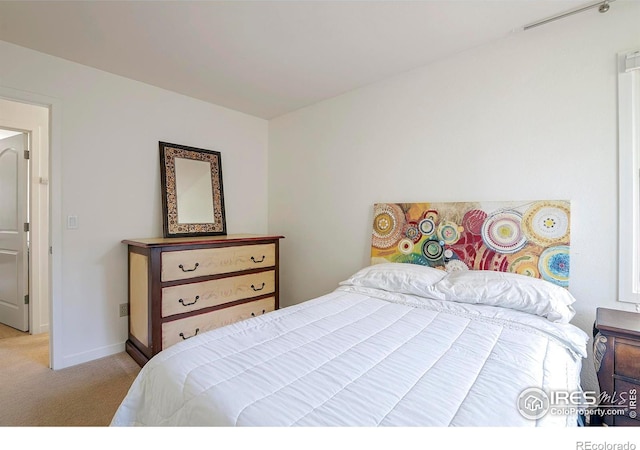 bedroom featuring light carpet