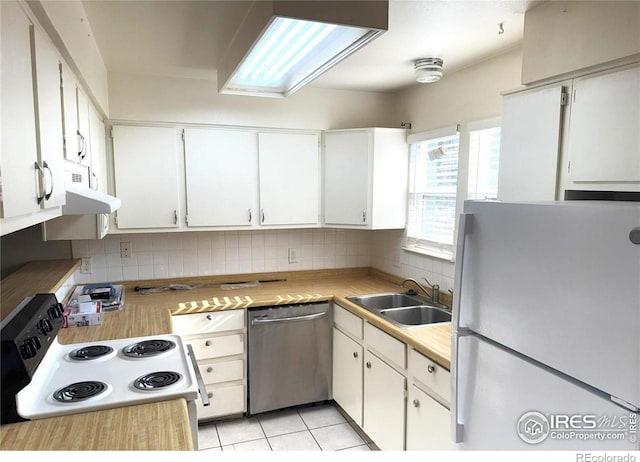 kitchen with white cabinetry, sink, dishwasher, and white fridge