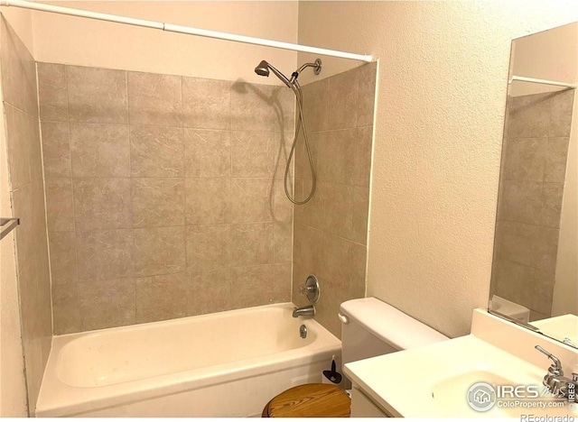 full bathroom featuring vanity, toilet, and tiled shower / bath combo