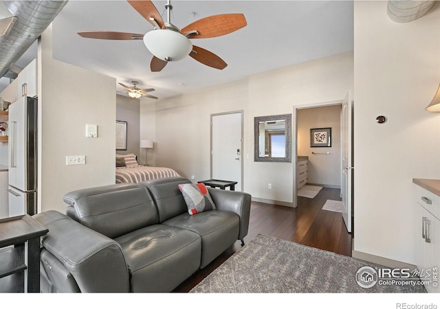 bedroom featuring high end fridge, dark wood finished floors, a ceiling fan, and baseboards