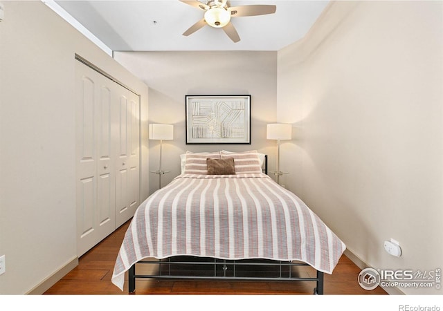 bedroom featuring a closet, ceiling fan, baseboards, and wood finished floors