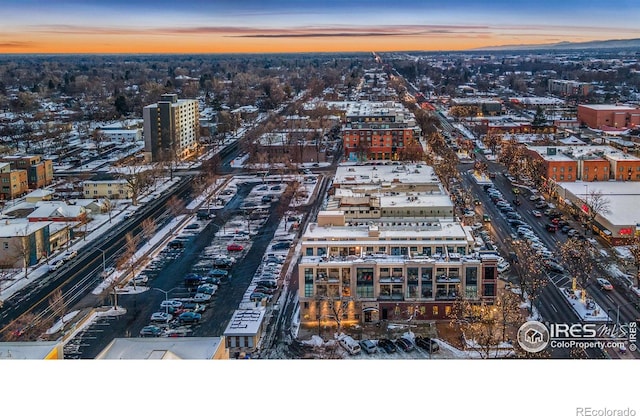 aerial view at dusk featuring a view of city