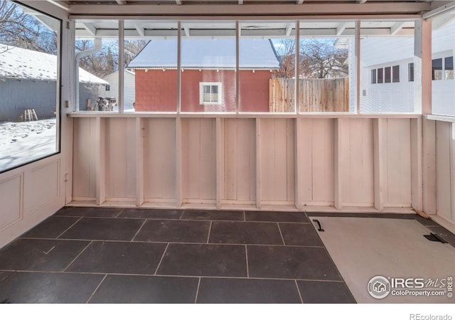 unfurnished sunroom featuring plenty of natural light