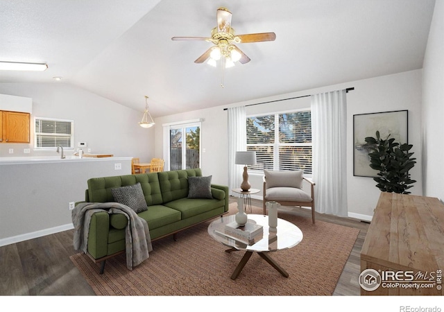 living room featuring lofted ceiling, dark wood-type flooring, and ceiling fan