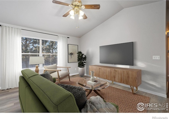 living room with ceiling fan, lofted ceiling, and light wood-type flooring