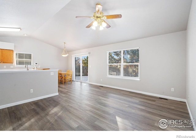 unfurnished living room featuring sink, vaulted ceiling, dark hardwood / wood-style floors, and ceiling fan