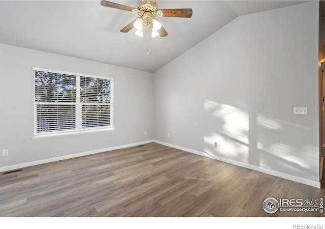 unfurnished room with hardwood / wood-style floors, vaulted ceiling, and ceiling fan