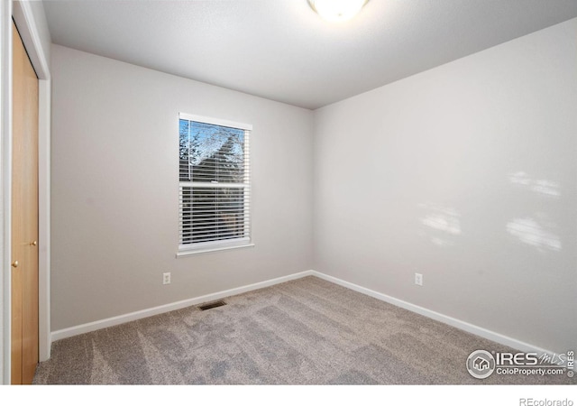 unfurnished room with carpet floors