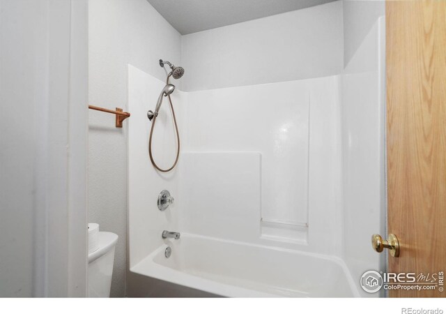 bathroom with toilet and shower / bath combination