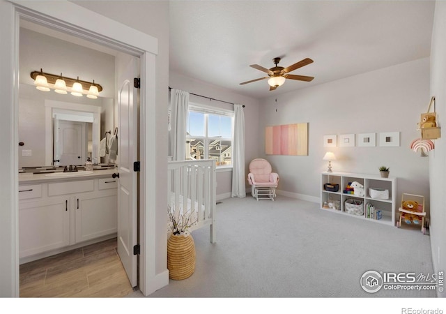 carpeted bedroom with connected bathroom and sink