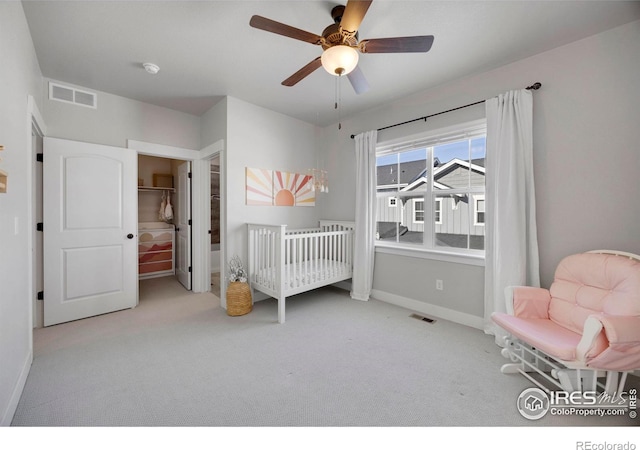 bedroom featuring light carpet and ceiling fan