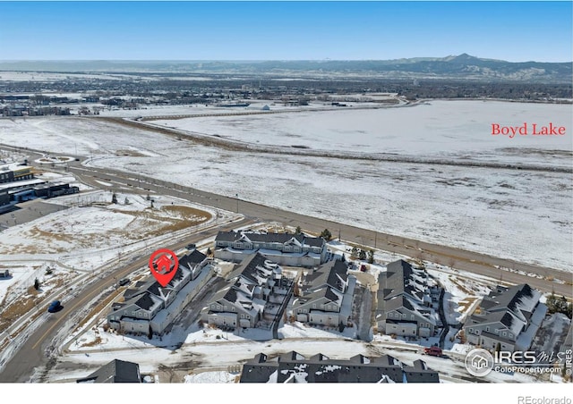 snowy aerial view featuring a mountain view