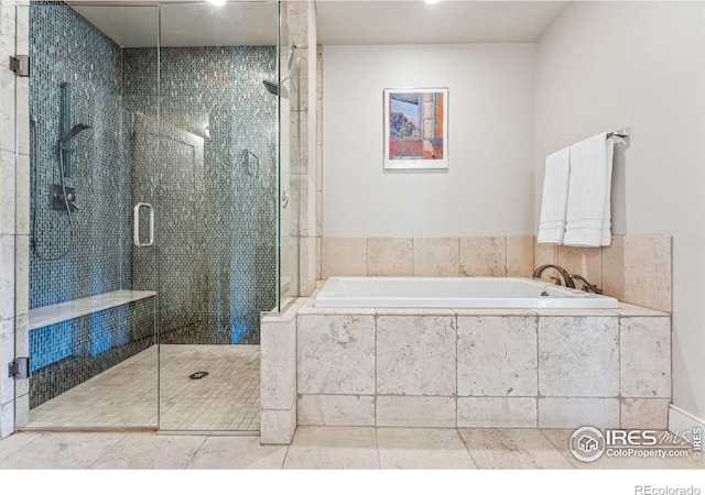 bathroom featuring shower with separate bathtub