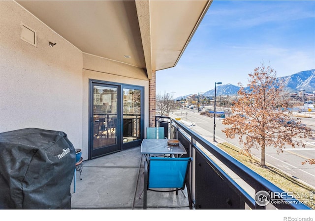 balcony with a mountain view and a grill