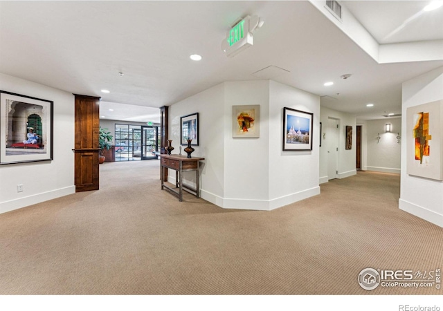 corridor with light colored carpet