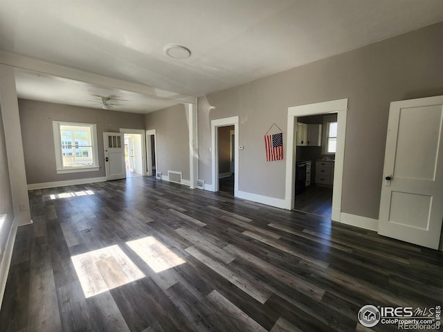 unfurnished living room with dark wood-type flooring and ceiling fan