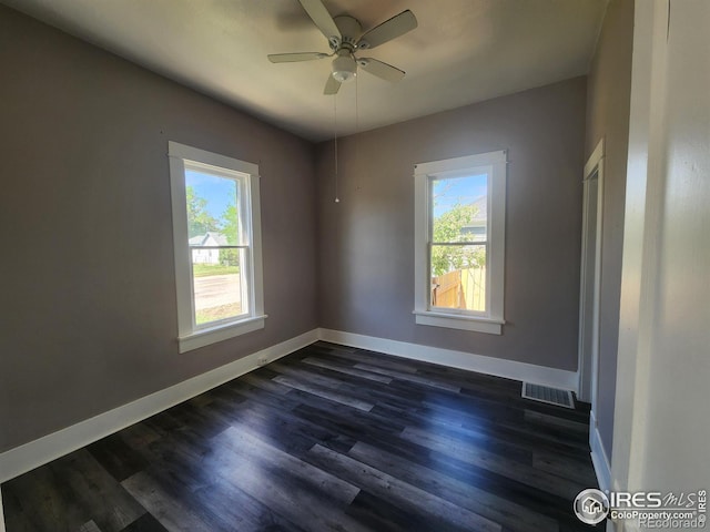 unfurnished room featuring ceiling fan and dark hardwood / wood-style floors