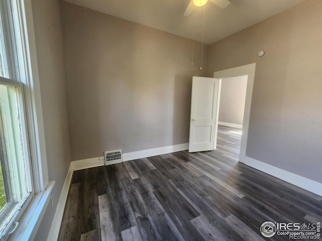 spare room with ceiling fan and dark hardwood / wood-style flooring