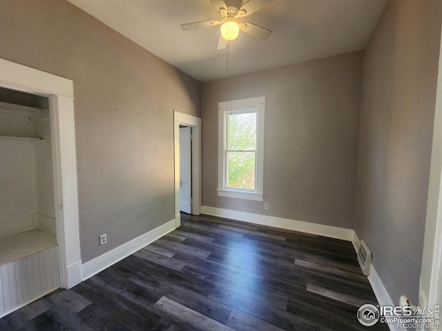 unfurnished bedroom with ceiling fan, dark hardwood / wood-style flooring, and a closet