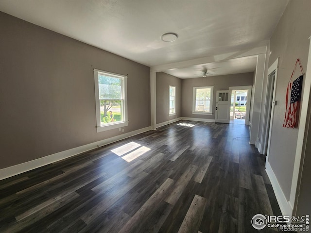 empty room with dark hardwood / wood-style flooring and ceiling fan