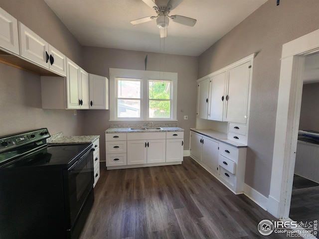 kitchen with sink, dark hardwood / wood-style floors, black range with electric cooktop, ceiling fan, and white cabinets