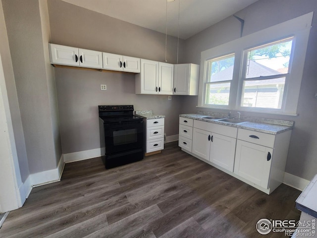 kitchen featuring dark hardwood / wood-style flooring, sink, electric range, and white cabinets