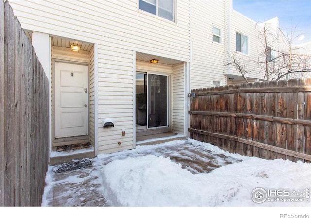 view of snow covered property entrance