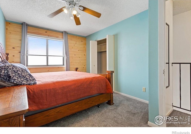 carpeted bedroom with a textured ceiling and ceiling fan