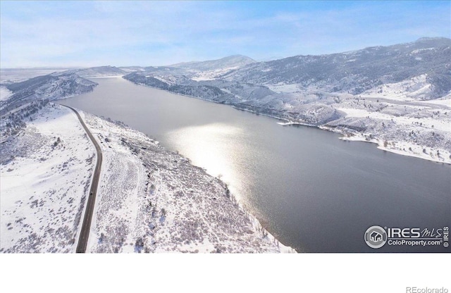 birds eye view of property featuring a water and mountain view