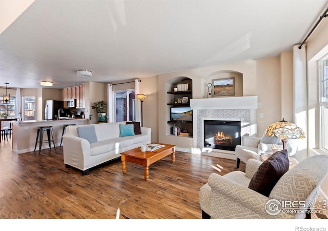 living area with plenty of natural light and wood finished floors