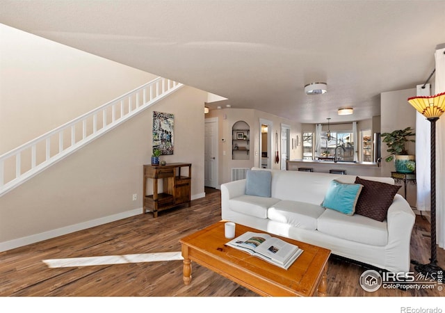 living room featuring sink and hardwood / wood-style floors