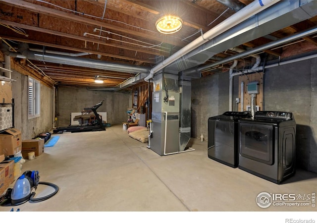 basement with heating unit and independent washer and dryer