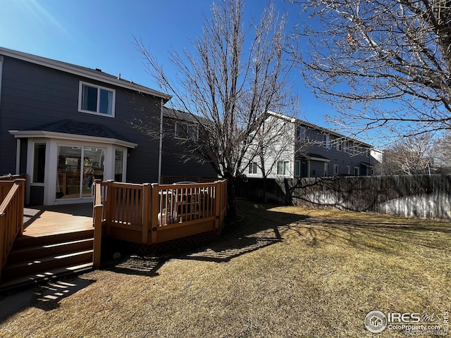 view of yard featuring a wooden deck and fence