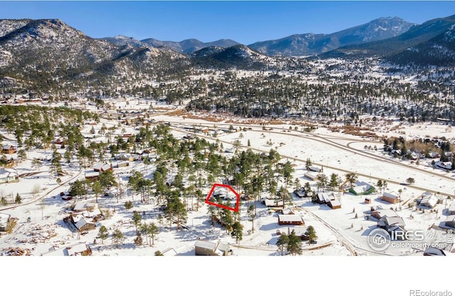 snowy aerial view featuring a mountain view