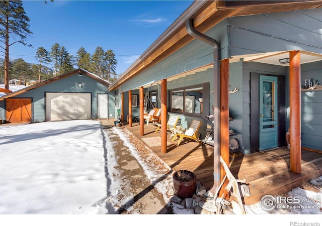 view of front of home with a garage and an outdoor structure