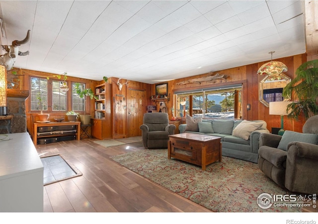 living room with wood walls and wood finished floors