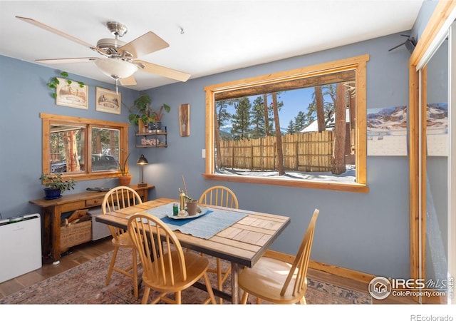 dining room featuring a ceiling fan and wood finished floors